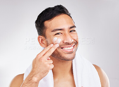 Buy stock photo Face, portrait and asian man with moisturizer in studio for skin hydration, anti aging or collagen. Lotion, male model or skincare with cosmetics for smooth, glow or soft texture by white background