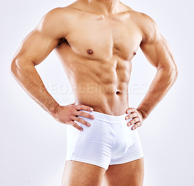 Buy stock photo Shot of a man posing in his underwear against a white studio background