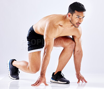 Buy stock photo Asian man, start or runner in studio for exercise, fitness training or cardio workout on white background. Topless, set or athlete ready for sports performance, sprinting race or running competition