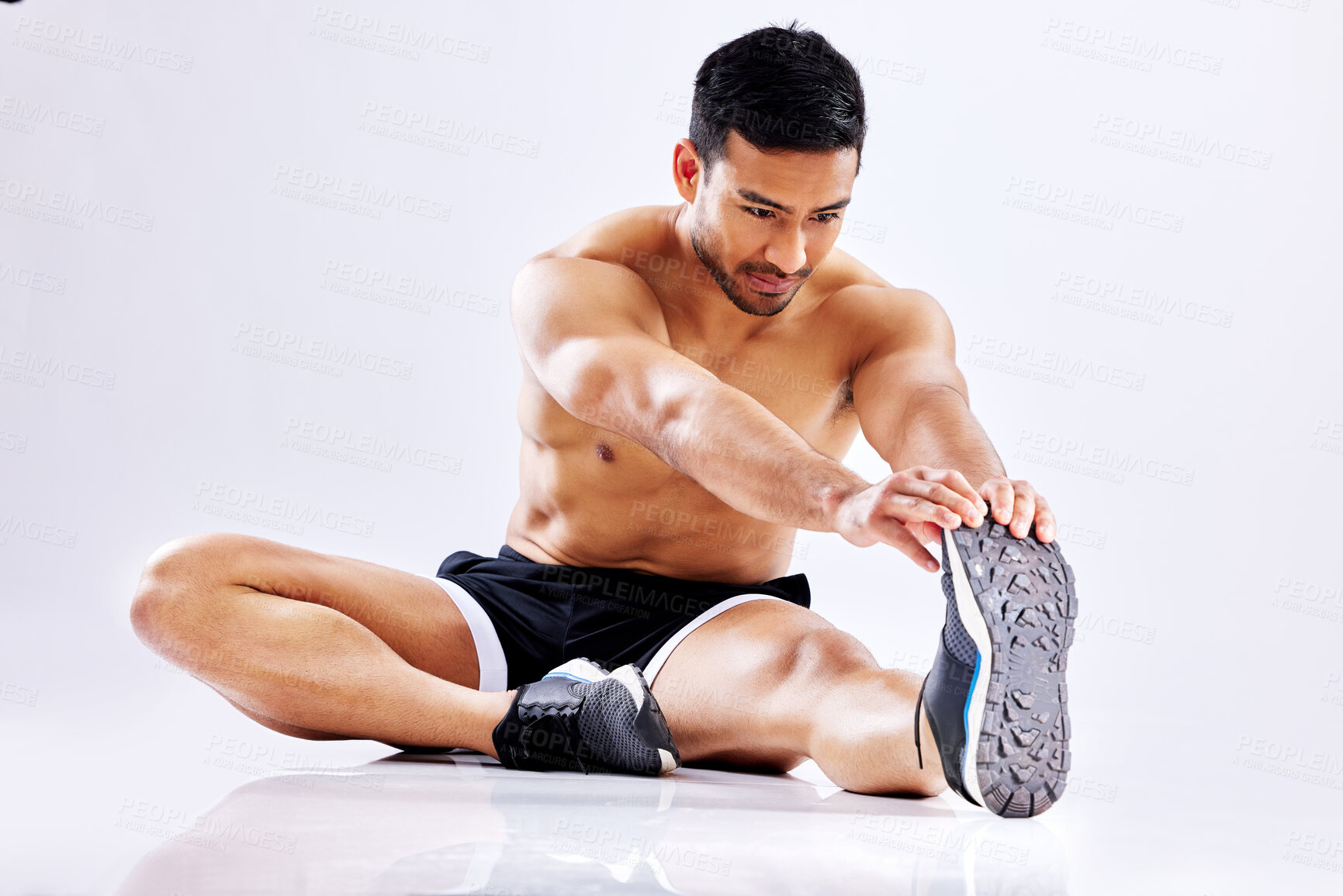 Buy stock photo Asian man, studio and stretching legs for workout exercise on ground or floor on white background. Warm up, fitness or sports athlete with flexibility for healthy body, release tension and muscle