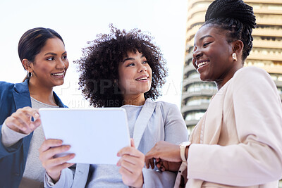 Buy stock photo Low angle shot of a diverse group of businesswomen standing outside on the balcony and using a digital tablet