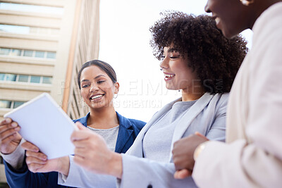 Buy stock photo Shot of a diverse group of businesswomen standing outside on the balcony and using a digital tablet