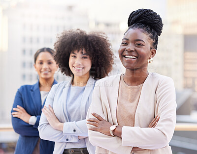 Buy stock photo Shot of a diverse group of businesswomen standing outside on the balcony with their arms folded