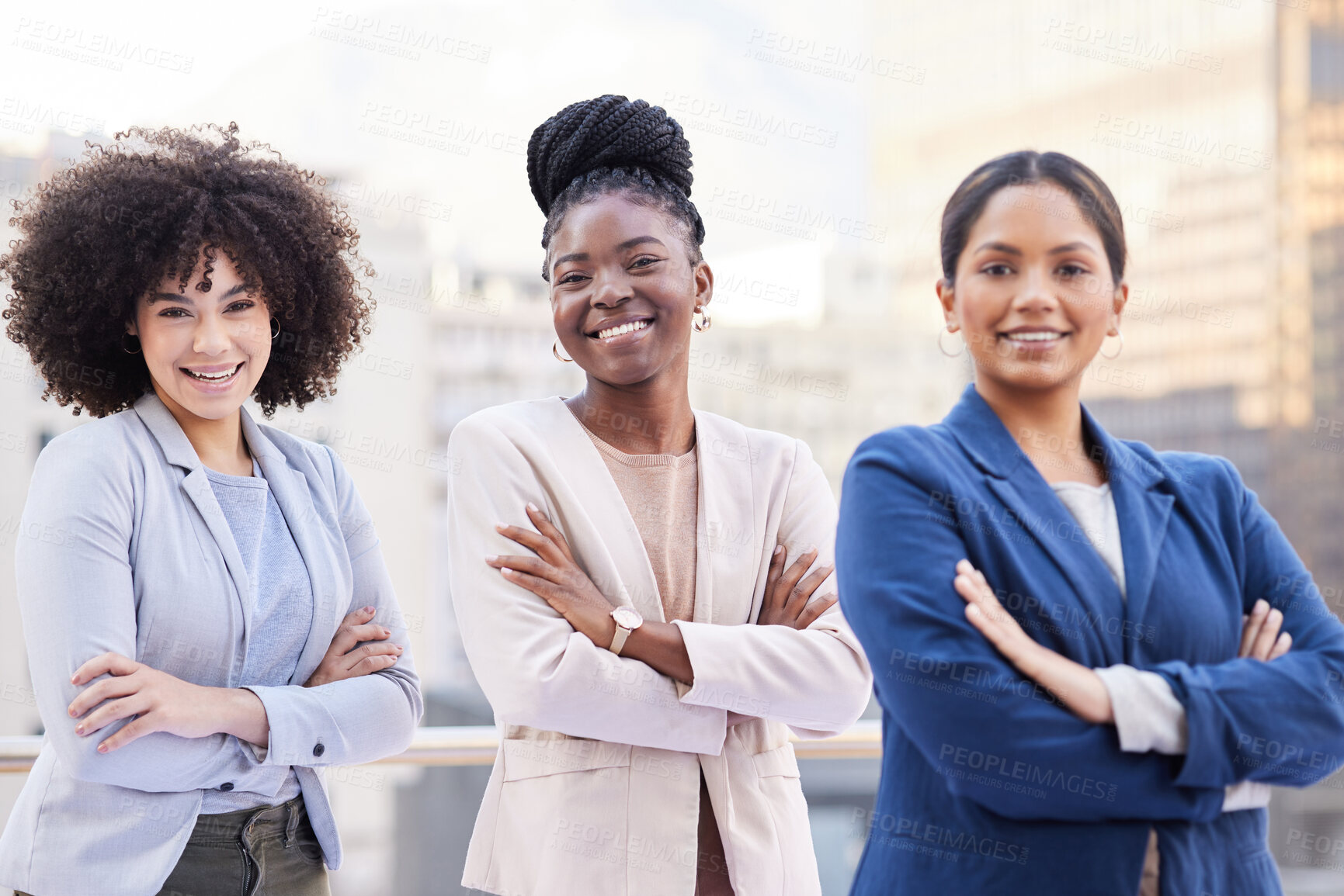 Buy stock photo Shot of a diverse group of businesswomen standing outside on the balcony with their arms folded