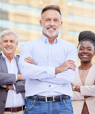 Buy stock photo Shot of a diverse group of businesspeople standing outside on the balcony with their arms folded