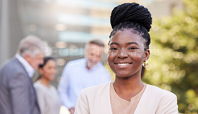 Buy stock photo Shot of an attractive young businesswoman standing outside while her colleagues discuss behind her