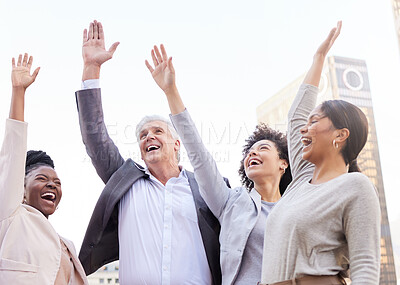 Buy stock photo Shot of a diverse group of businesspeople standing outside together with their arms raised