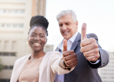 Buy stock photo Shot of two businesspeople standing outside on the balcony together and showing a thumbs up