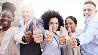 Buy stock photo Shot of a diverse group of businesspeople standing outside on the balcony together and showing a thumbs up