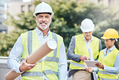 Buy stock photo Portrait of a confident mature businessman holding blueprints while working at a construction site