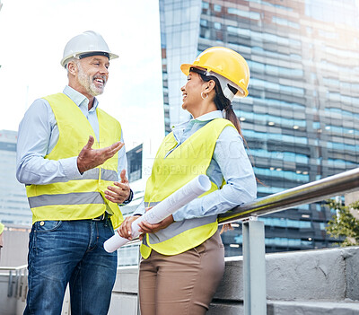 Buy stock photo Shot of two businesspeople working together at a construction site