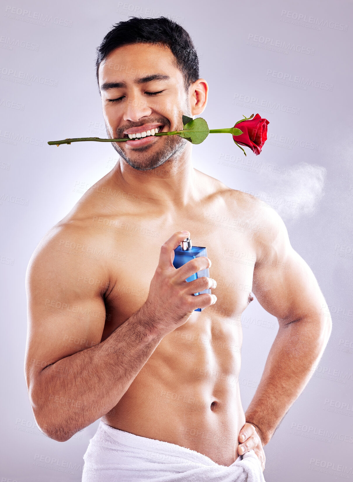 Buy stock photo Flower, cologne and man with spray from cosmetics on studio background with rose perfume. Skincare, deodorant and floral smell for valentines day or getting ready for date with romantic scent