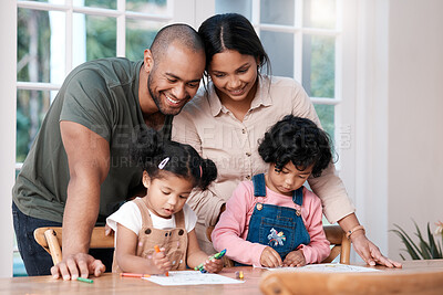 Buy stock photo Shot of a couple watching their two little daughters colouring with crayons at home