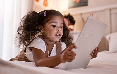Buy stock photo Shot of a little girl using a digital tablet at home