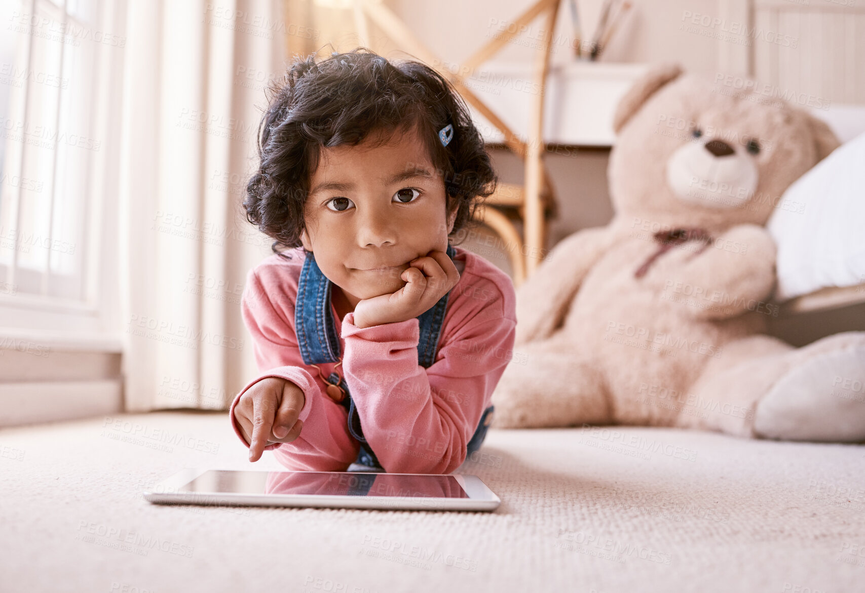 Buy stock photo Shot of a little girl using a digital tablet at home