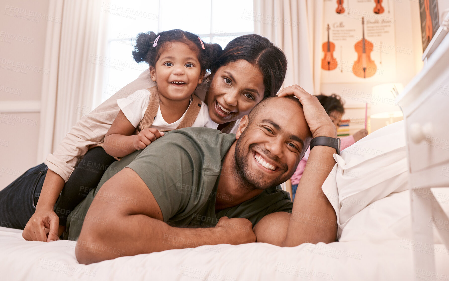 Buy stock photo Shot of a young family relaxing at home