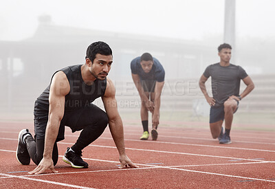 Buy stock photo Shot of a male athlete ready to begin a race