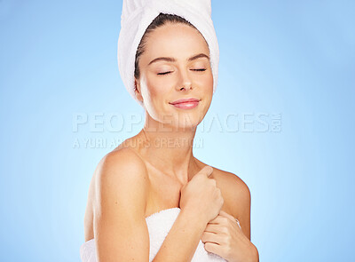 Buy stock photo Skincare, woman and towel in studio for beauty with morning grooming, wellness and natural cosmetics. Model, dermatology and relax after shower for clean body, skin health and glow by blue background