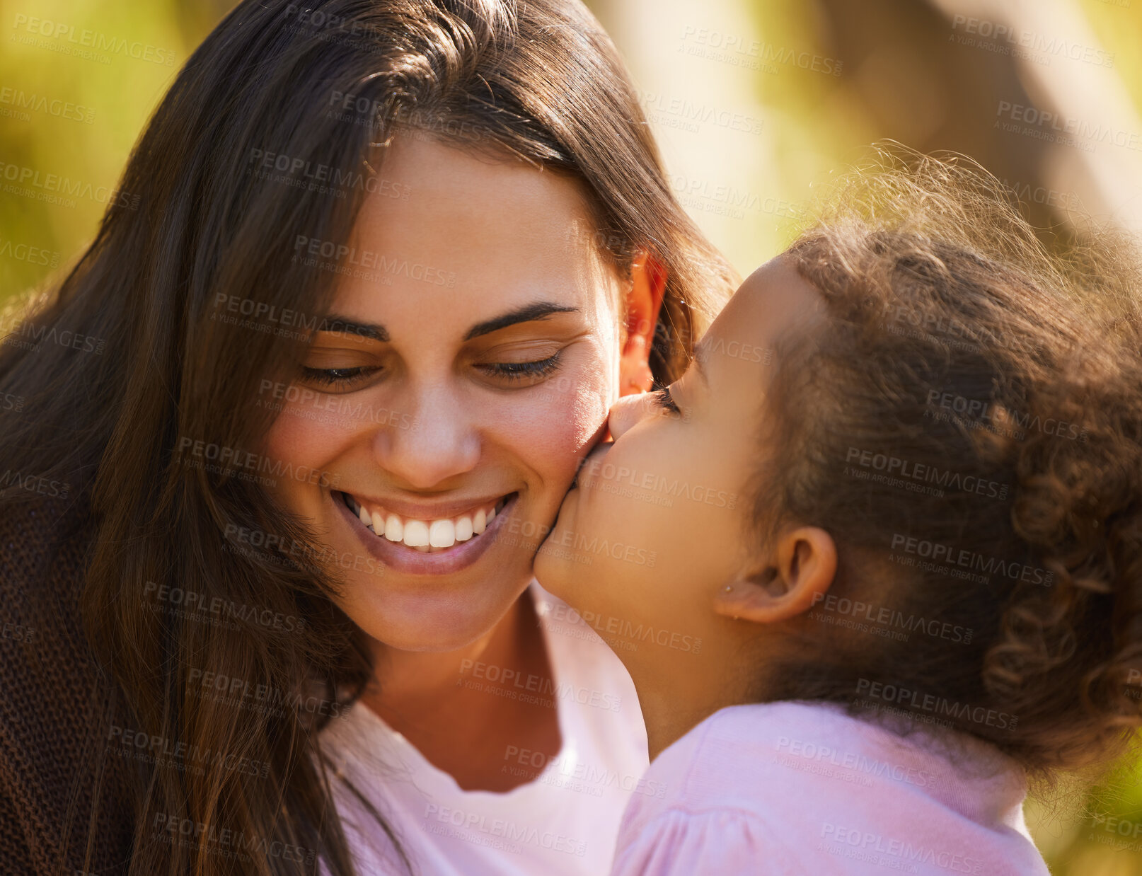 Buy stock photo Mother, child and kiss in park for love, smile and bonding to connect in childhood at garden. Mom, daughter and support for security in outdoor nature, happiness and affection or care in relationship