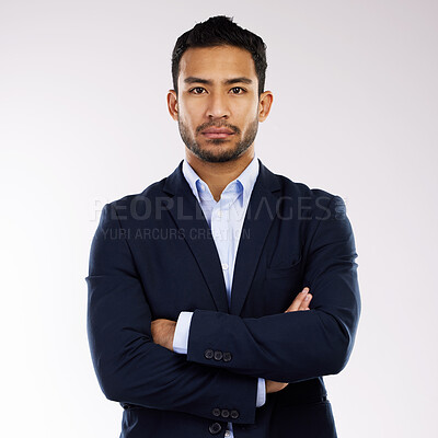 Buy stock photo Studio portrait of a confident young businessman standing with his arms crossed against a white background