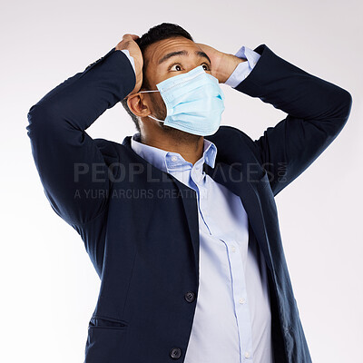 Buy stock photo Studio shot of a young businessman wearing a face mask and looking stressed out against a white background