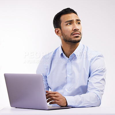 Buy stock photo Studio shot of a young businessman looking worried while using a laptop against a white background