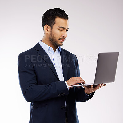 Buy stock photo Studio shot of a young businessman using a laptop against a white background