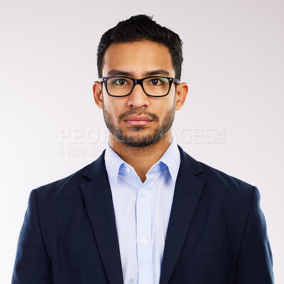 Buy stock photo Studio shot of a serious young man posing against a grey background