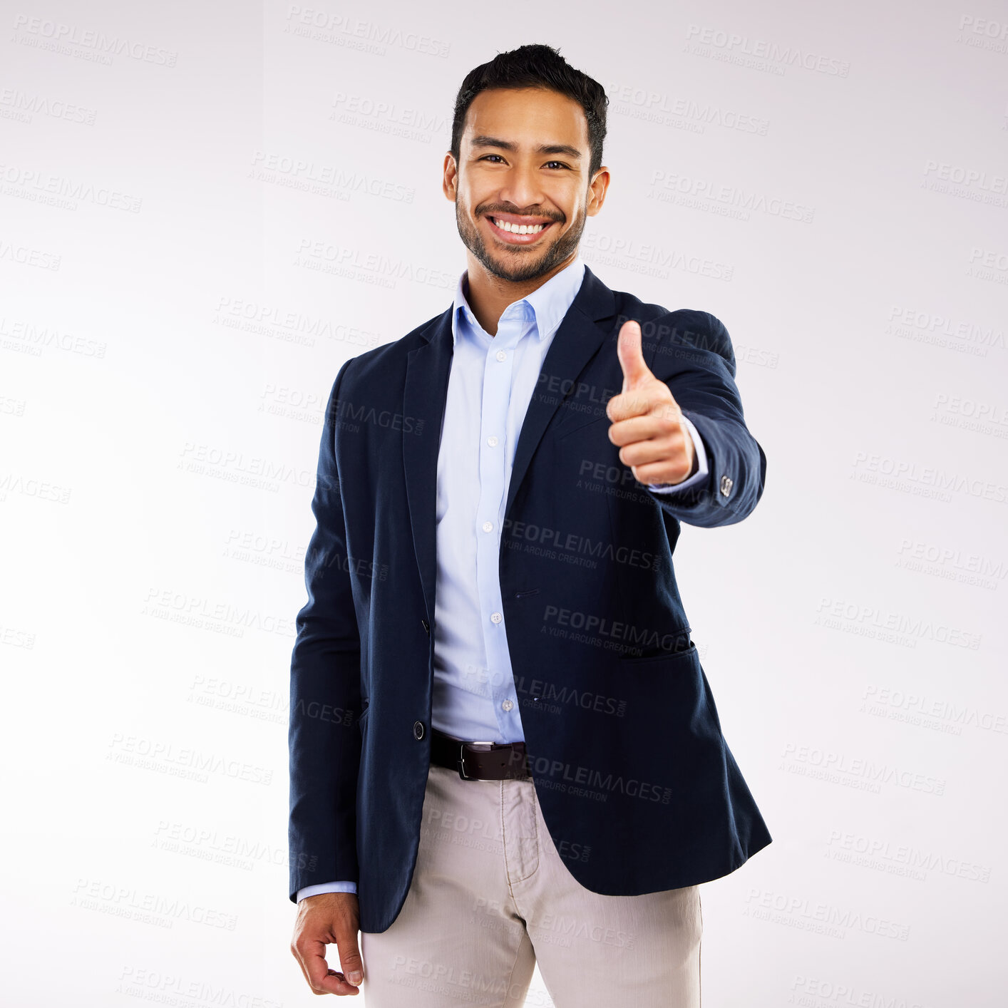 Buy stock photo Studio shot of a young man showing a thumbs up gesture against a white background