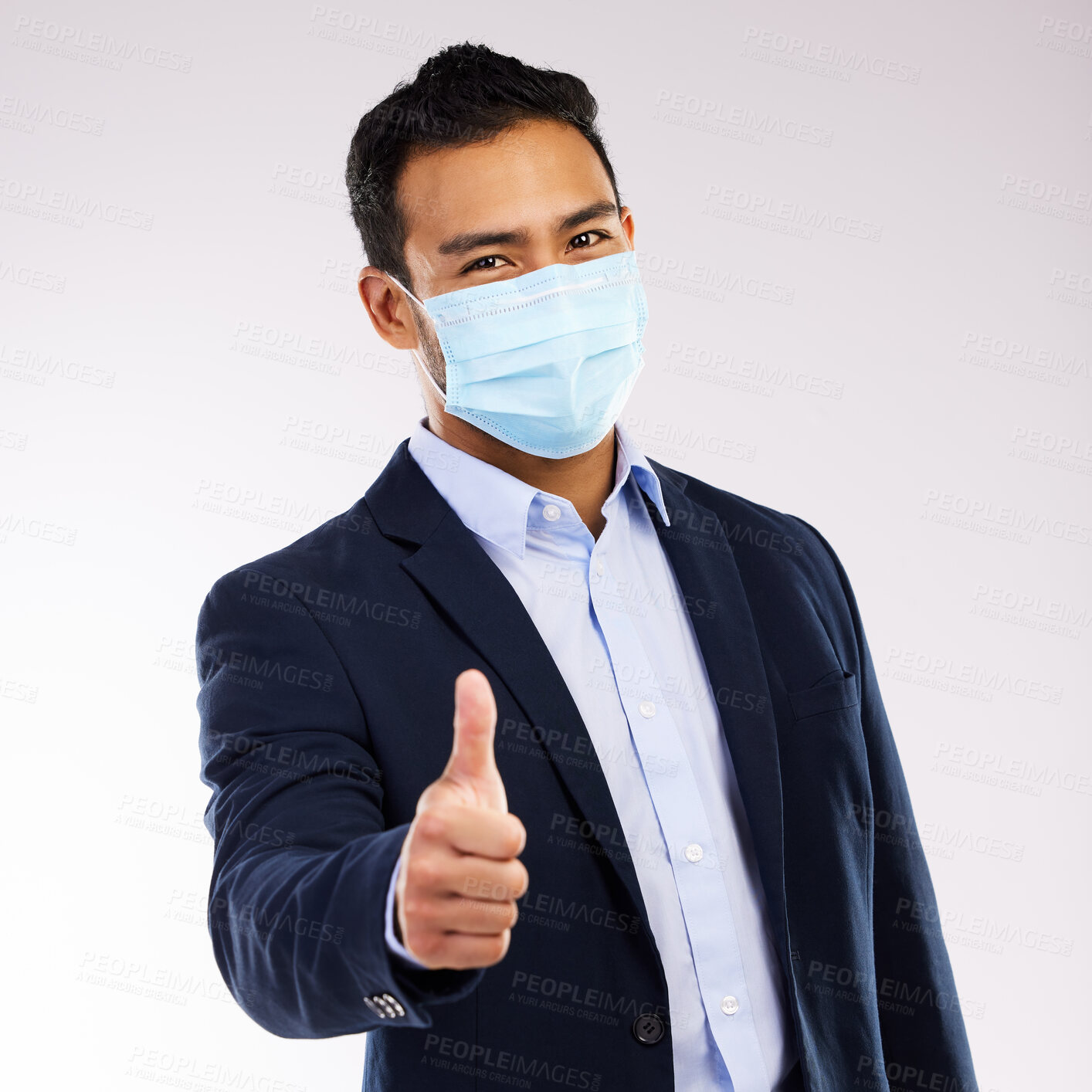 Buy stock photo Studio shot of a young man showing a thumbs up gesture against a white background