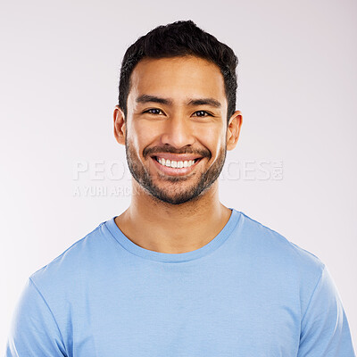 Buy stock photo Studio shot of a handsome and happy young man posing against a grey background