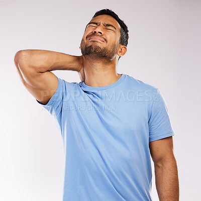 Buy stock photo Studio shot of an young man experiencing some pain against a grey background