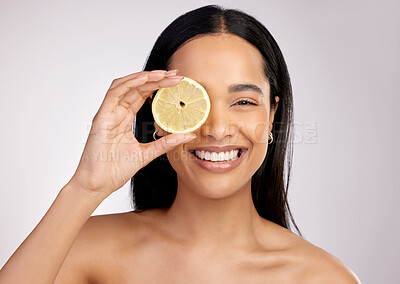 Buy stock photo Happy woman, portrait and lemon for natural vitamin C, citrus or healthy nutrition against a grey studio background. Face of female person with fruit in skincare, collagen or antioxidant for diet