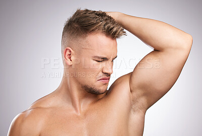 Buy stock photo Man, smelling and armpit in studio for health, cleaning and wellness or body oudor. Male person, skincare and hygiene in bathroom for cosmetics, perfume and antiperspirant by white background