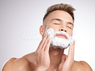 Buy stock photo Man, eyes close and shaving cream on face in studio, grooming and facial care for beard hair removal with product. Foam, skincare and dermatology or cosmetology, cleaning hygiene and white background