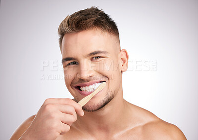 Buy stock photo Portrait, man and brushing teeth for hygiene with wellness, dental care and gum health for fresh breath in studio. Male person, toothbrush and clean mouth with oral benefits by white background