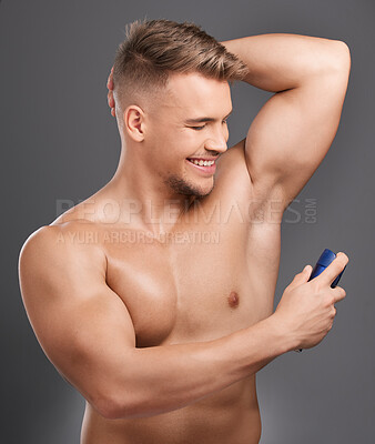 Buy stock photo Happy man, deodorant and armpit with spray for health, cleaning and wellness or body care. Male person, skincare and hygiene in bathroom for routine, cosmetics and perfume by studio background