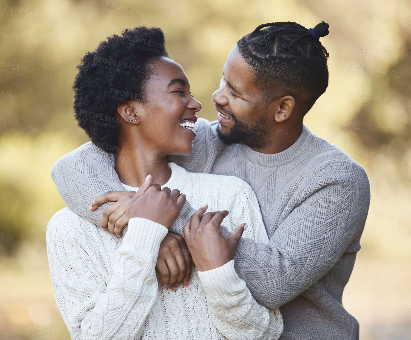 Buy stock photo Black man, hug and woman in countryside for love, holiday and adventure or winter camping trip. Couple, support and embrace outdoor for date, comfort and together with care and smile in forest 