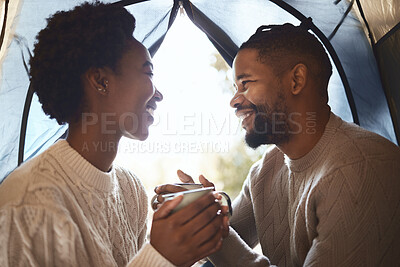 Buy stock photo Shot of a couple enjoying a cup of tea in their tent during a camping trip