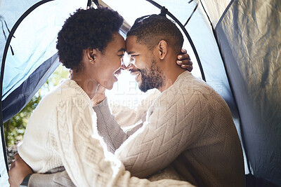 Buy stock photo Shot of a young couple spending time together in their tent while camping