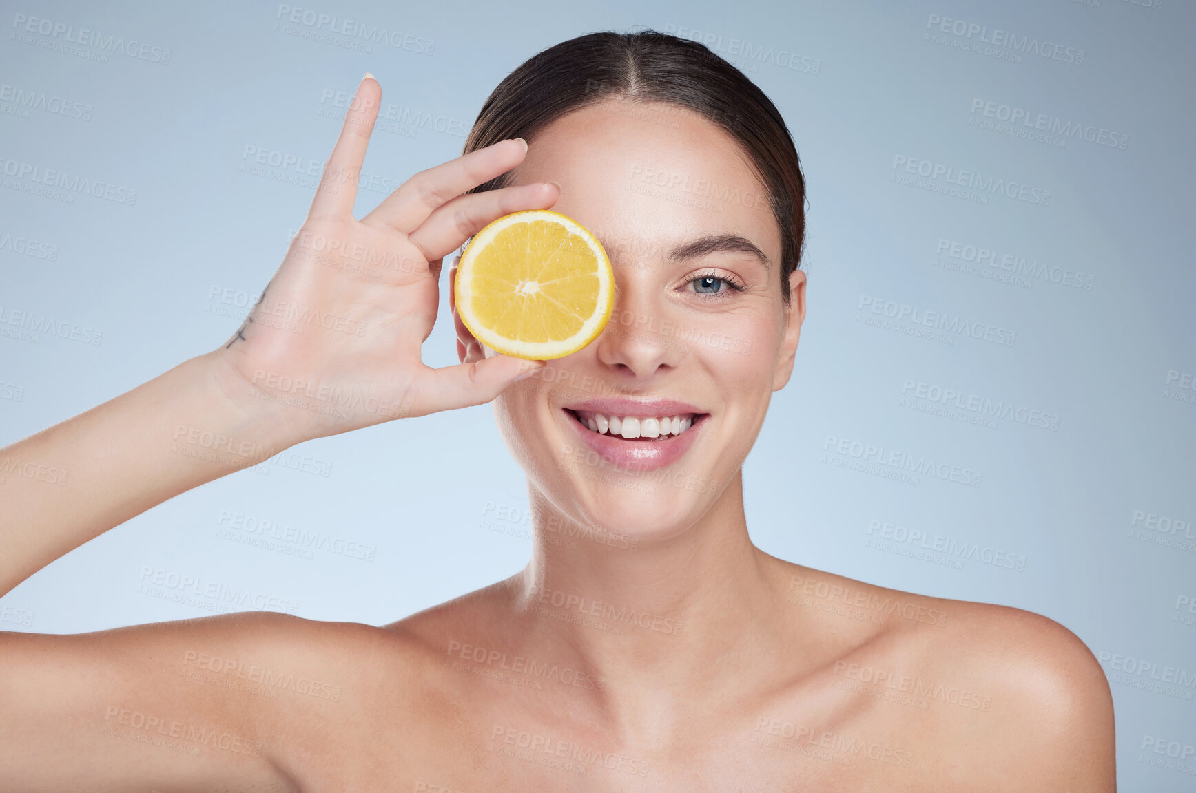 Buy stock photo Portrait smile, woman and lemon for skincare with vegan diet, healthy nutrition and beauty in studio. Happy model, citrus fruit and dermatology for vitamin c glow, shine and detox by gray background