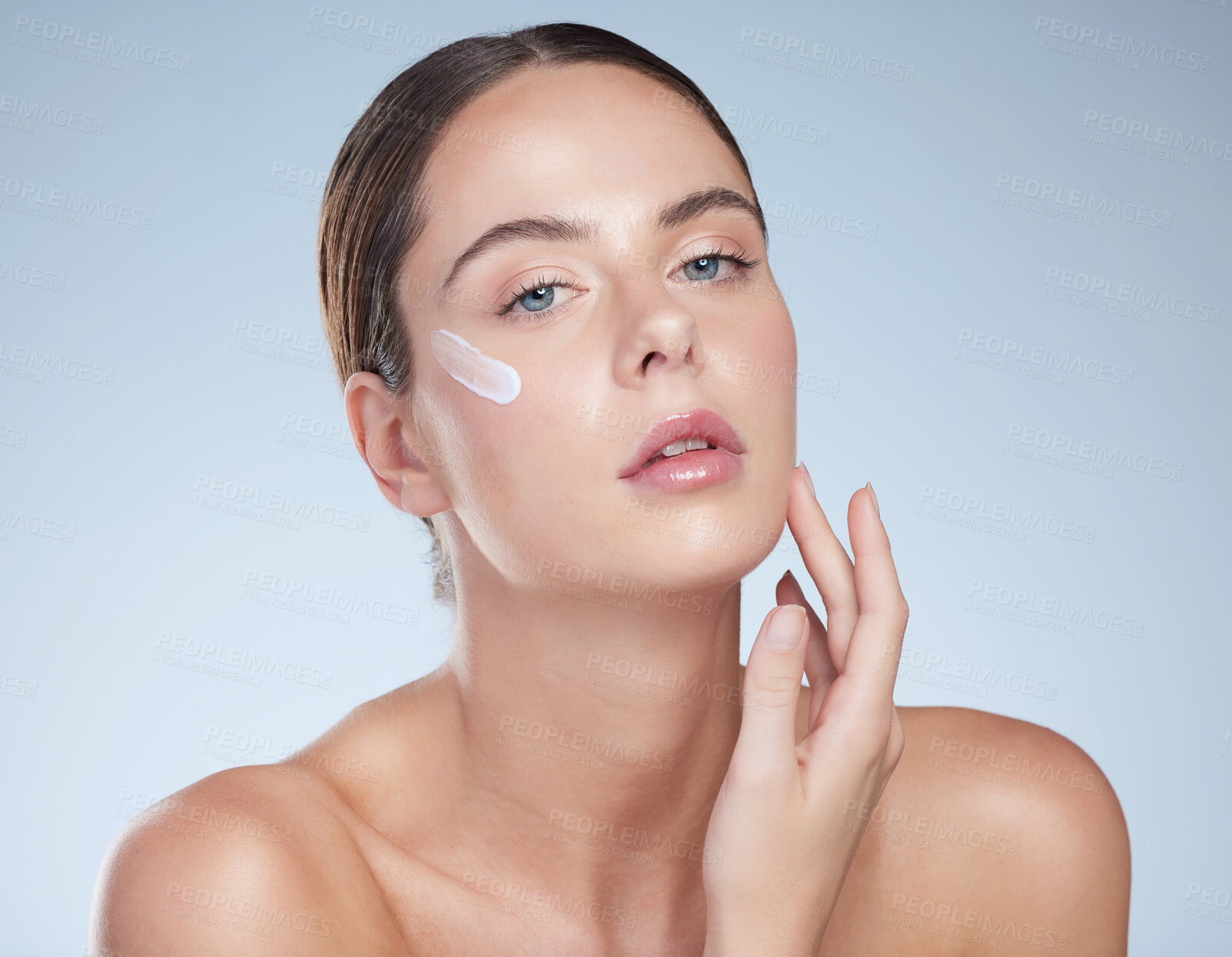 Buy stock photo Woman, portrait and cream for clear skin in studio portrait, hydration and beauty on blue background. Person, application and lotion for facial treatment, skincare and hyaluronic acid moisturizer