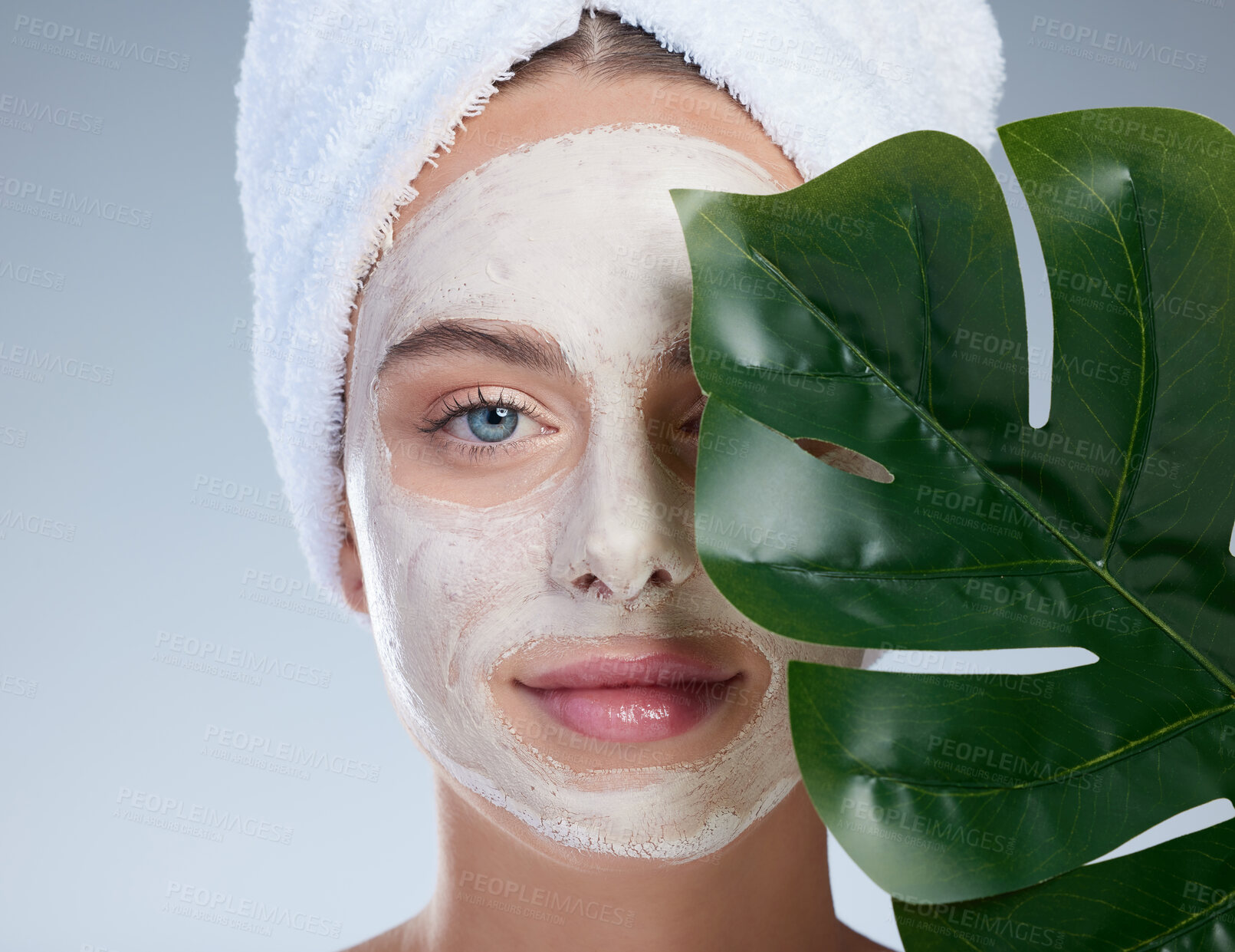 Buy stock photo Woman, leaf and face mask for skincare in studio, vegan beauty and treatment on blue background. Female person, natural cosmetics and cleaning product to exfoliate, sustainable dermatology and detox