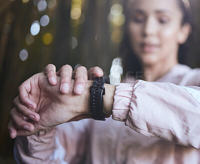 Buy stock photo Woman, hands and watch for fitness in outdoor, runner and heartbeat tracker during workout in woods. Female person, athlete and check digital timer for update, gps and monitor pulse or cardio stats