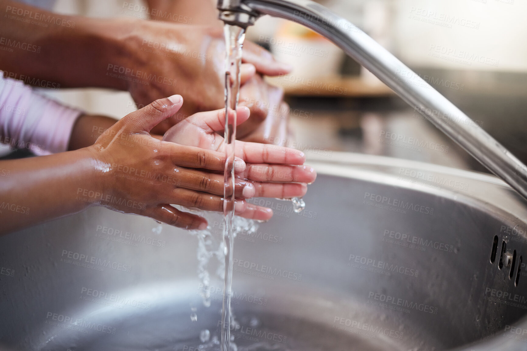 Buy stock photo Closeup shot of a father helping his daughter wash her hands at a tap at home