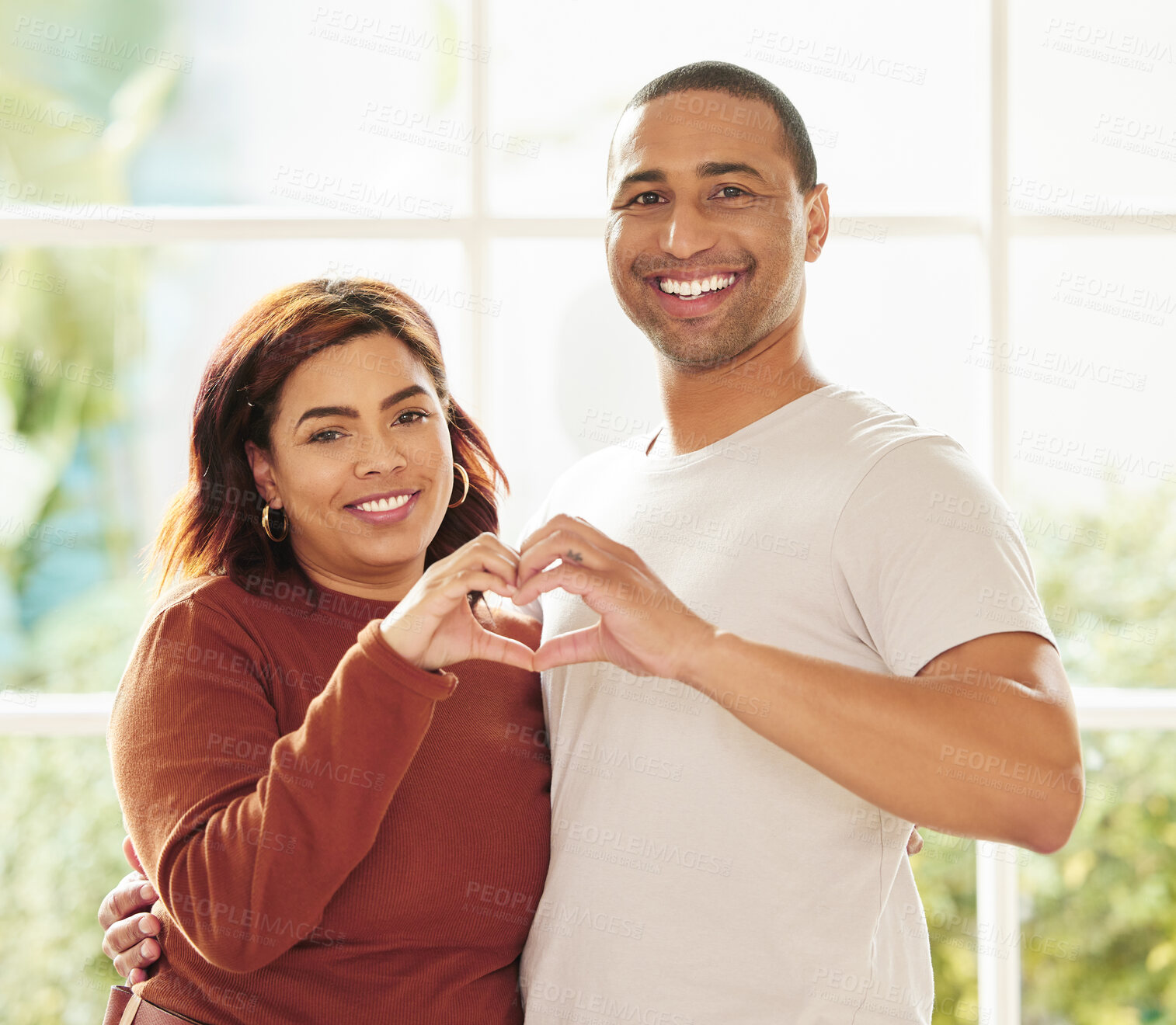 Buy stock photo Couple, portrait and hands for heart in home, hug and support for love emoji or symbol and together. People, embrace and romance sign for marriage, security and happiness in relationship for trust