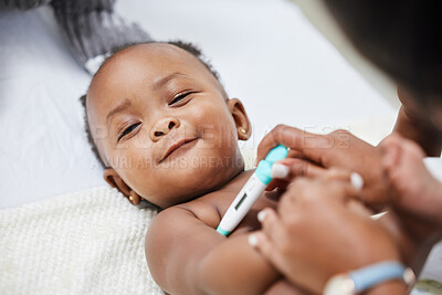 Buy stock photo Shot of a little baby having her temperature taken by a doctor with a thermometer