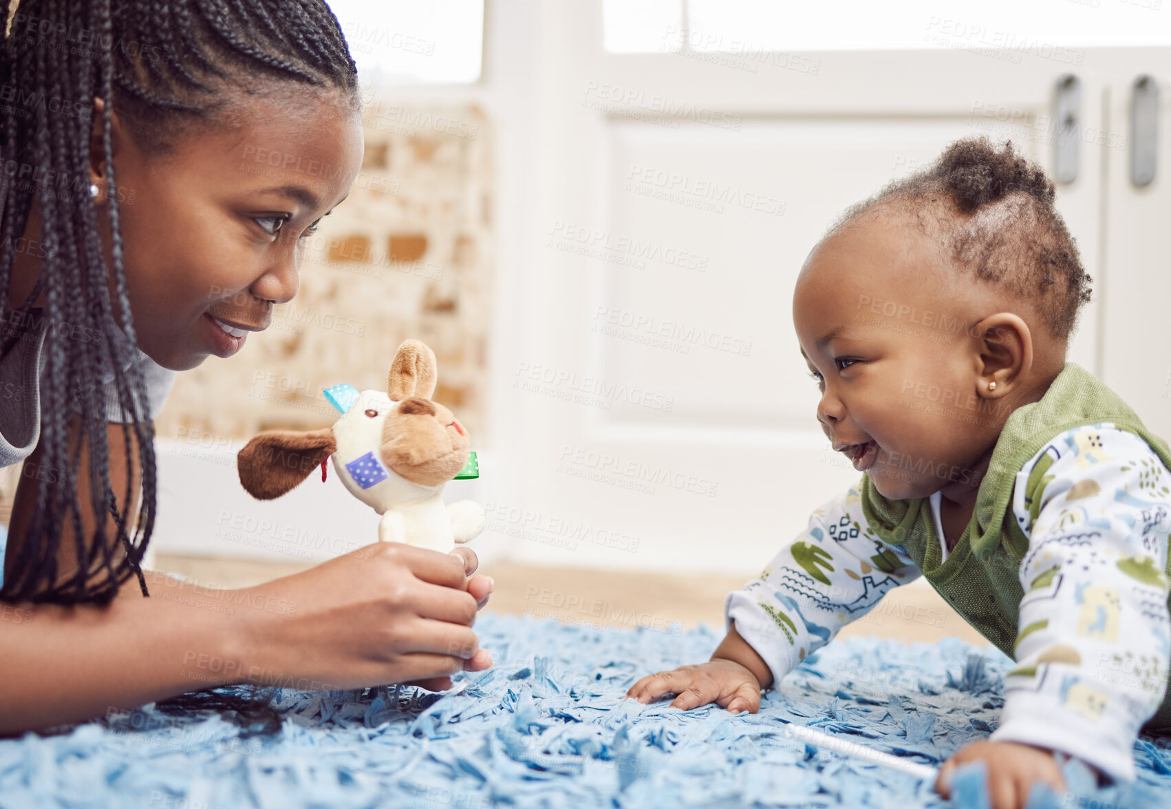 Buy stock photo Shot of a young woman bonding with her baby at home