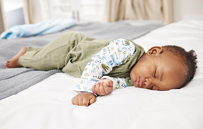 Buy stock photo Shot of a baby boy sleeping on a bed