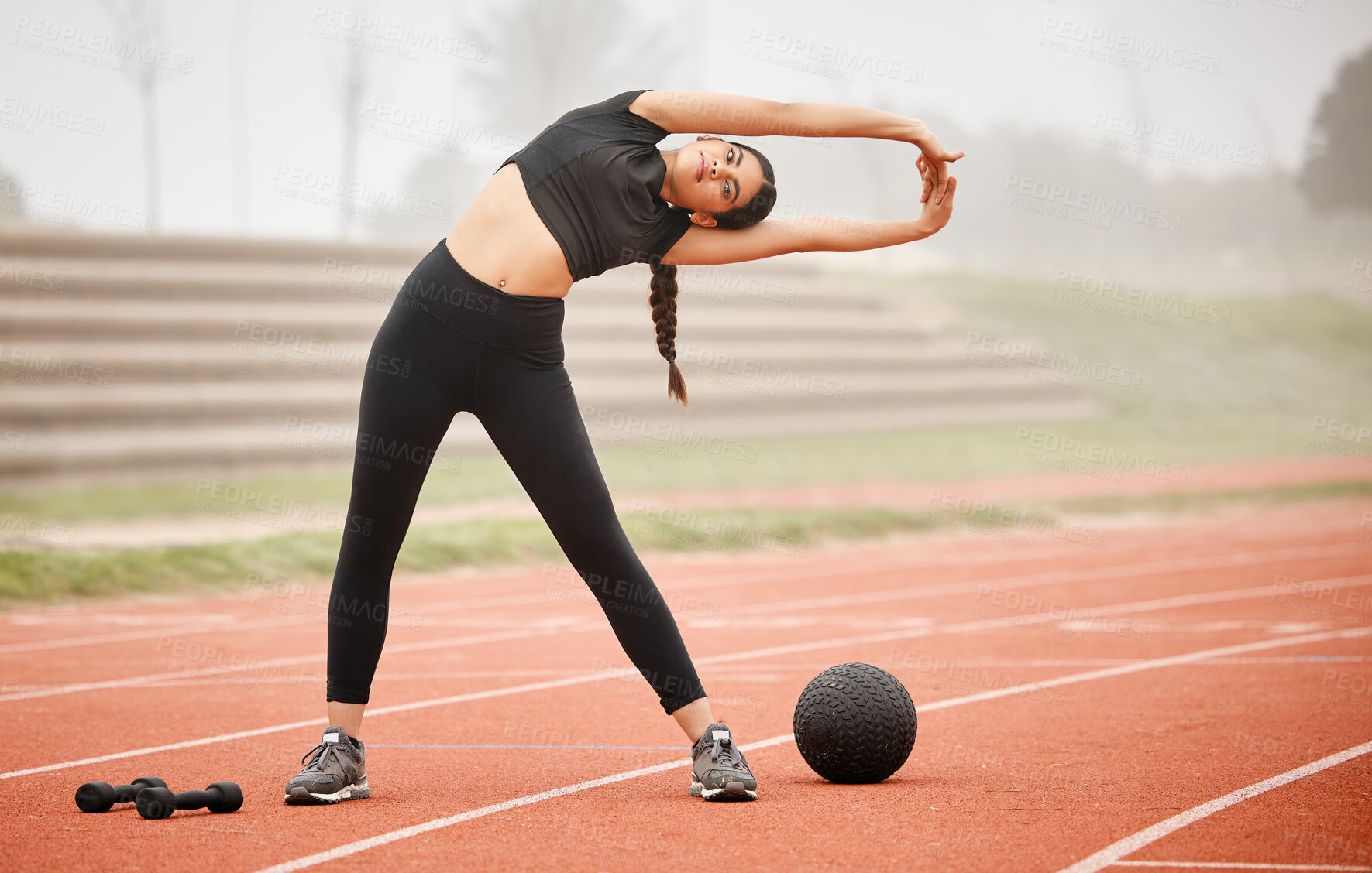 Buy stock photo Woman, portrait and stretching arms at stadium, runner and training in outdoor for fitness at track. Female person, warm up and flexibility for muscle or athlete for wellness, getting ready and arena